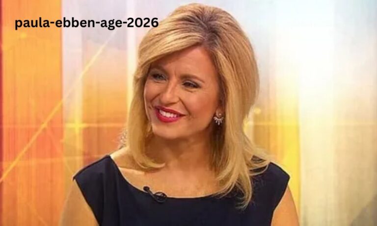 Paula Ebben, veteran news anchor for WBZ-TV Boston, speaking professionally at the news desk in a blue suit and microphone.